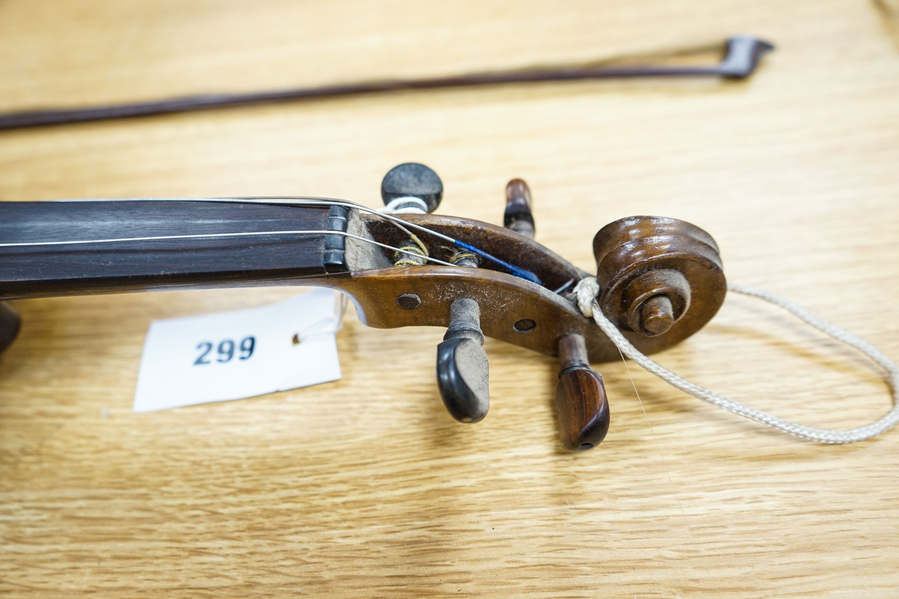 A violin labelled Francesco Ruggeri and a bow. Back of violin excluding button - 36cm